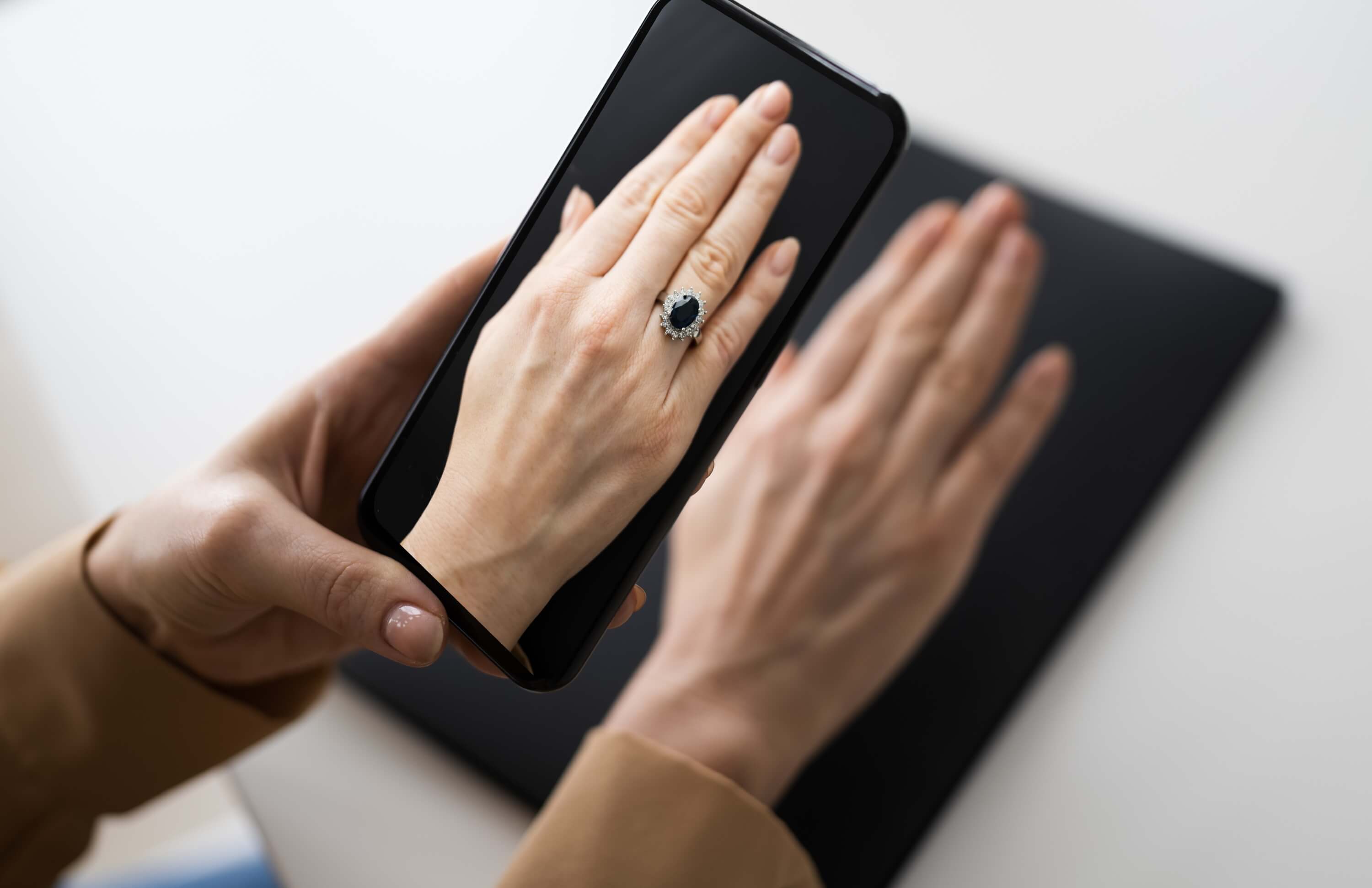 Using AR/VR technology to try on a ring via smartphone for an immersive jewelry experience.