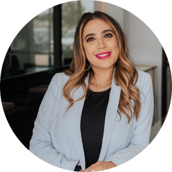 Seema Patel, jewelry designer at Seema Jewelry & Co, smiling in a professional setting wearing a light blue blazer.