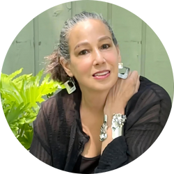 Suzanne Schwartz, jewelry designer at Stitched Jewelry, wearing bold statement pieces.