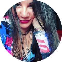 Dahna Mak, jewelry designer at Madame Mak Jewellery, smiling with vibrant attire and jewelry.